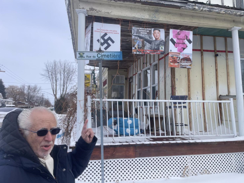 B'nai Brith Canada's Henry Topas, pointing earlier this year at the Nazi symbols displayed on the house in Saint-Bernabe Sud